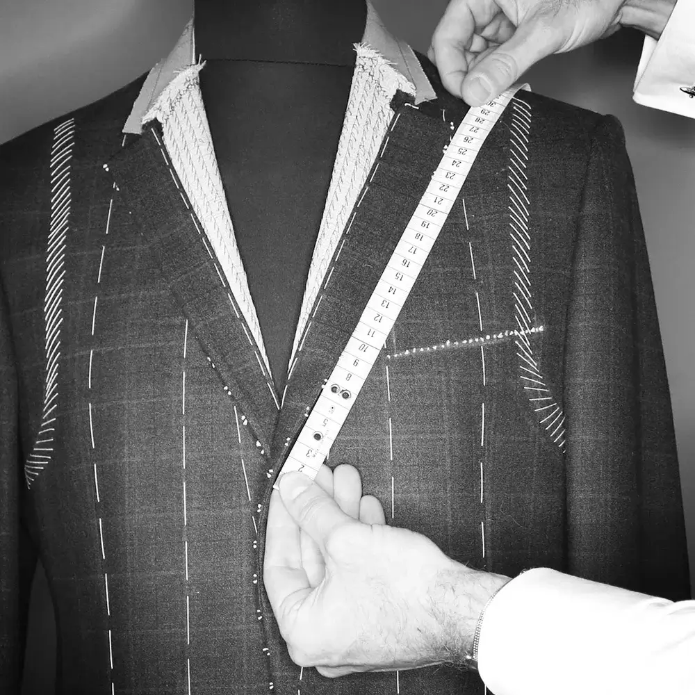 Master tailor measuring fabric